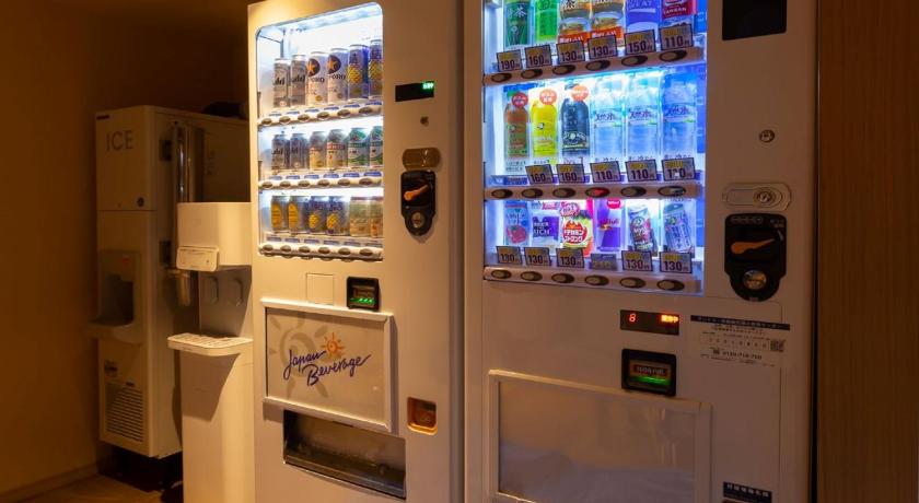 a white refrigerator filled with lots of different types of drinks, Hotel Niwa Tokyo in Tokyo