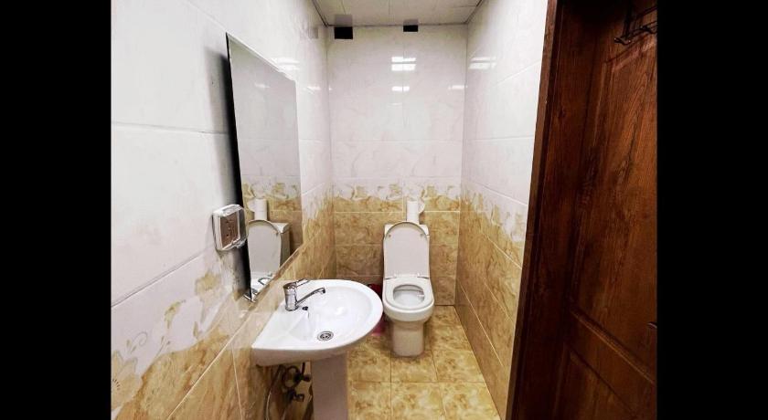 a bathroom with a toilet, sink, and mirror, Gobi Guest House in Ulaanbaatar