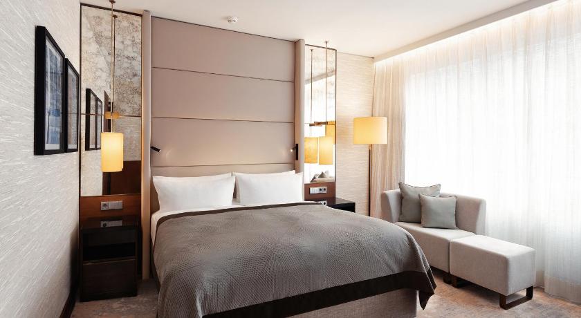 a bedroom with a bed and a dresser, InterContinental Berlin in Berlin