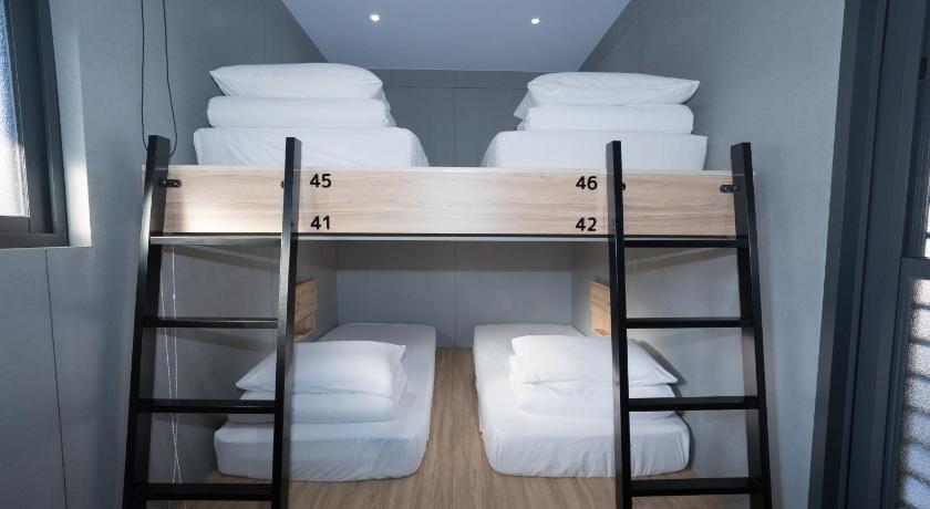 two bunk beds in a room with a window, liuqiu dive hostel in liu