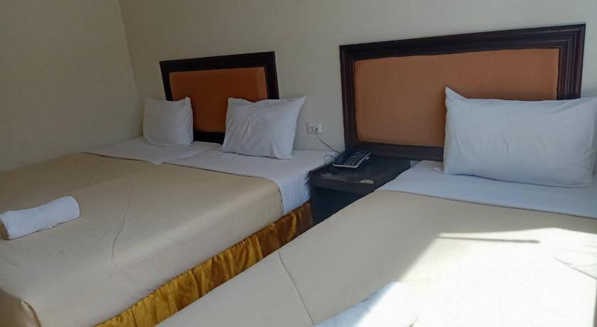 a hotel room with two beds and two lamps, Princess Park Hotel in Surat Thani