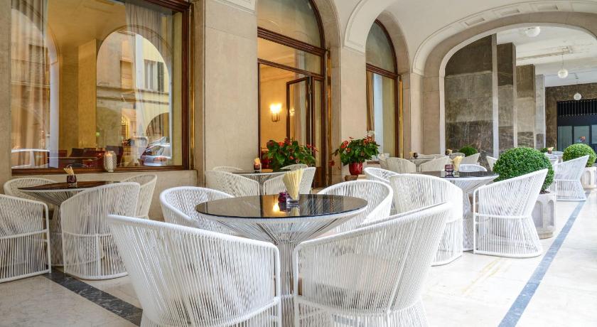 a large room with tables and chairs in it, Hotel Vittoria in Brescia