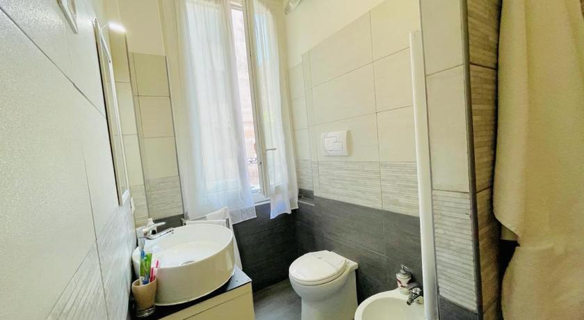 a white toilet sitting next to a white sink, Appunti Di Viaggio Guesthouse in La Spezia