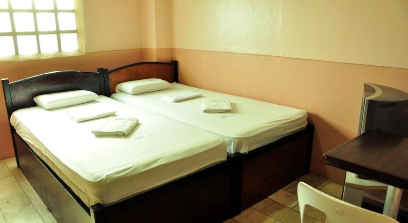 a hotel room with two beds and a desk, GV Hotel Ipil (Zamboanga Sibugay) in Ipil
