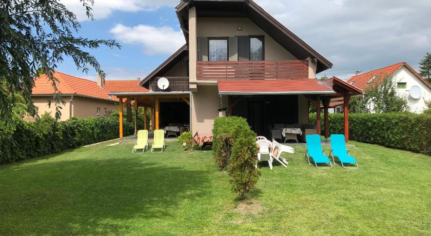 a house with a bunch of lawn chairs in front of it, Maria Villa in Balatonlelle