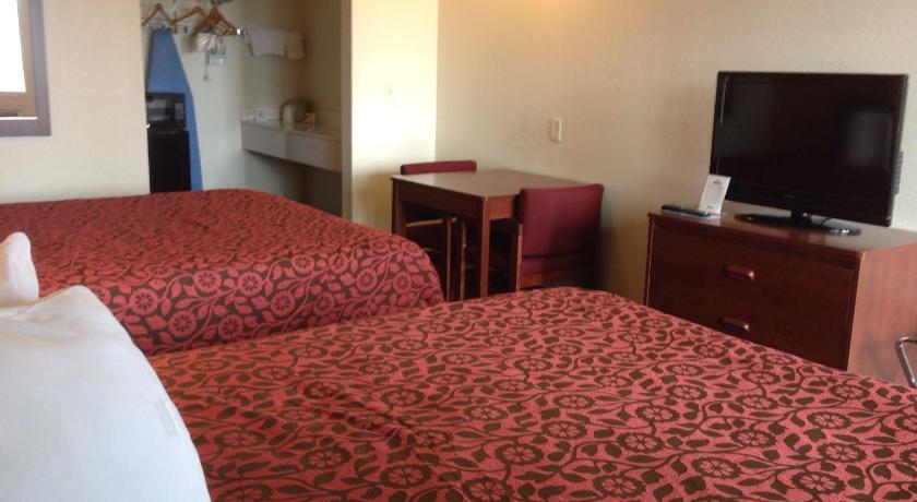 a hotel room with two beds and a television, Days Inn by Wyndham Andover in Andover (KS)