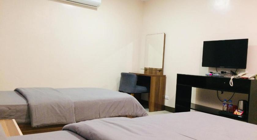a bedroom with a bed and a television, YBC GRAND HOTEL in Subic (Zambales)