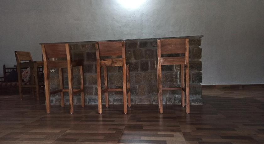 an empty room with a table and chairs, Kwality Estate in Coorg