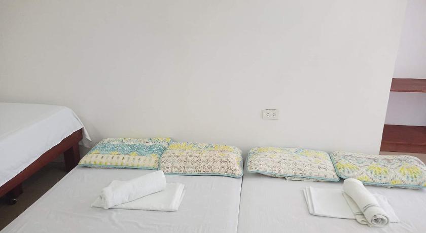 a bed room with two beds and a desk, Catalina`s Inn in Bohol