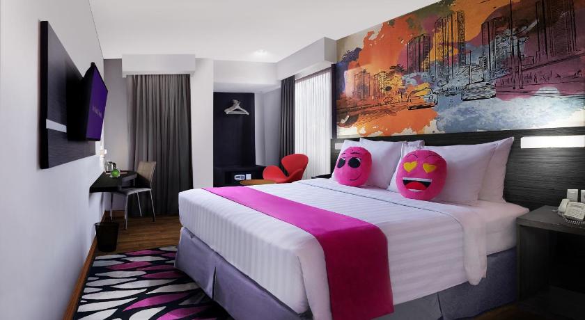 a hotel room with a bed and a painting on the wall, Favehotel Graha Agung Surabaya in Surabaya