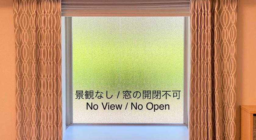 a sign on a wall in front of a window, Richmond Hotel Tokyo Suidobashi in Tokyo