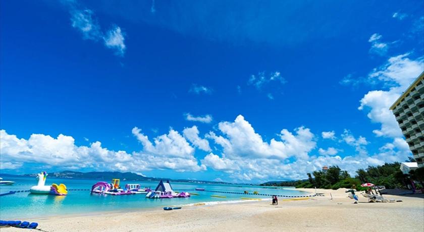 a beach scene with people on the beach, Kanehide Kise Beach Palace in Okinawa Main island