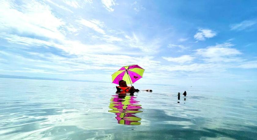 a person in the water with an umbrella, Toliz Beach House -Sipaway Island San Carlos City in San Carlos (Negros Occidental)