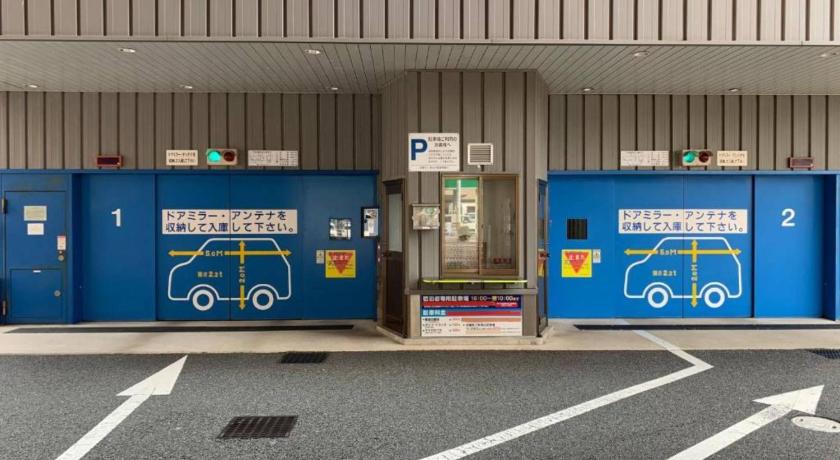 a row of blue and yellow refrigerators in a parking lot, Toyoko Inn Shin-yamaguchi-eki Shinkansen-guchi in Yamaguchi