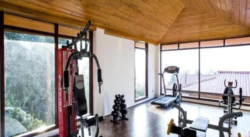 a room with a bike rack and a large window, The Chumbi Mountain Retreat Resort and Spa in Pelling