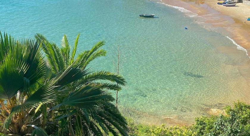 a beach with palm trees and palm trees, Bravacasa Geriba Buzios Luxury Inn in Buzios