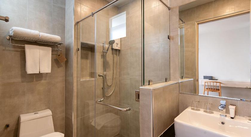 a bathroom with a toilet, sink, and shower, The Pride Hotel , Phitsanulok in Phitsanulok