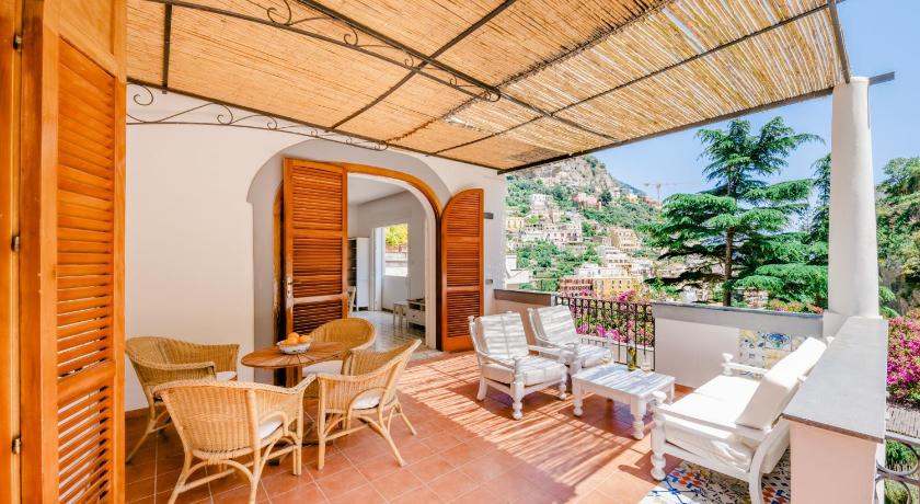 a patio area with a table and chairs, Villa Alimede in Positano