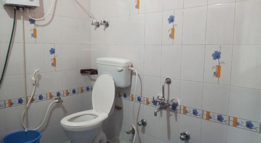 a bathroom with a toilet, sink, and shower stall, Sabaoth Stays, in Coorg