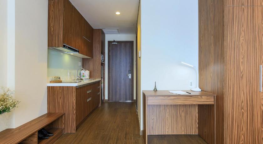a kitchen with a refrigerator, sink, and cabinets, Aurora Serviced Apartments in Ho Chi Minh City