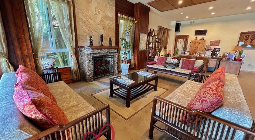 a living room filled with furniture and a fire place, I-Think Resort in Nantou