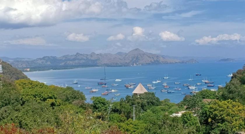 a large body of water surrounded by mountains, CF Komodo Hotel in Labuan Bajo