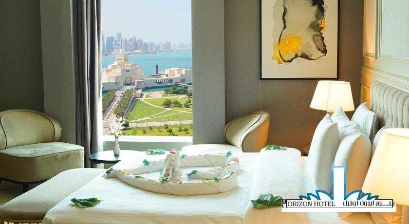 a hotel room with a table and chairs, Horizon Manor Hotel in Doha