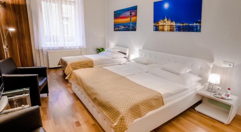 a hotel room with a bed, desk and a lamp, Anabelle Bed and Breakfast Budapest in Budapest