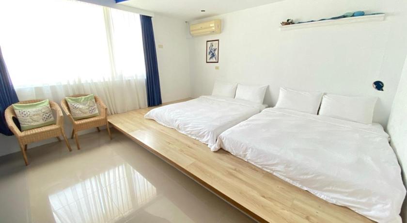 a bedroom with a bed and a desk, Craftsman Inn in Kenting