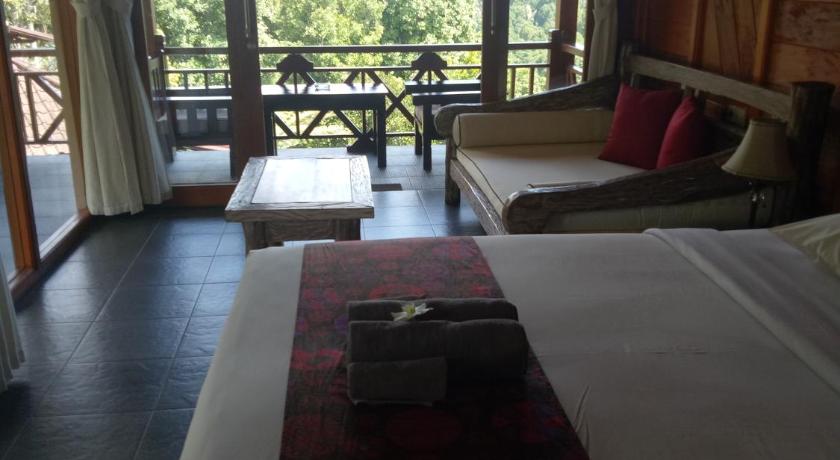 a bedroom with a bed and a window, Villa Dua Bintang in Bali