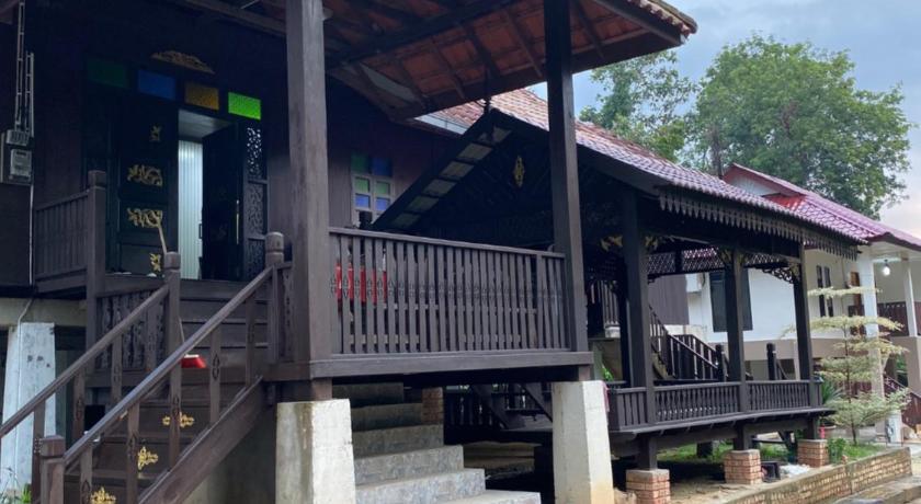 a building with a wooden roof and a wooden bench, Teratak Sekayu ( Room Stay ) in Jengka