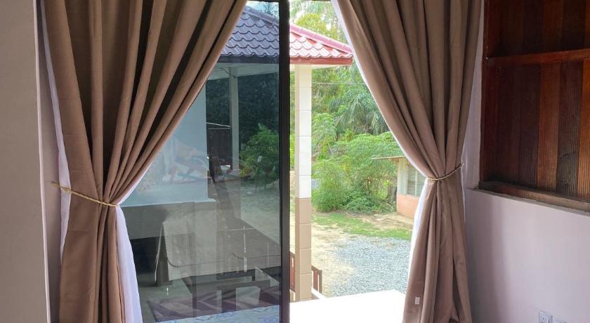 a bedroom with a bed and a window, Teratak Sekayu ( Room Stay ) in Jengka