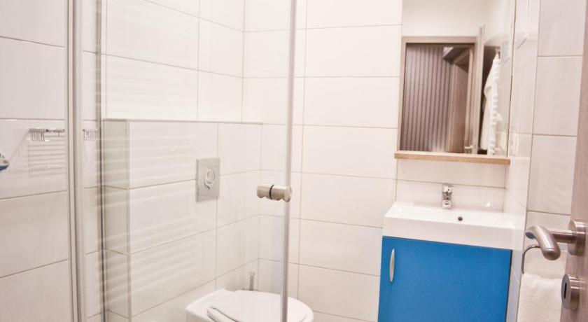 a bathroom with a toilet, sink, and shower, Levendula Apartmanhaz in Sarvar