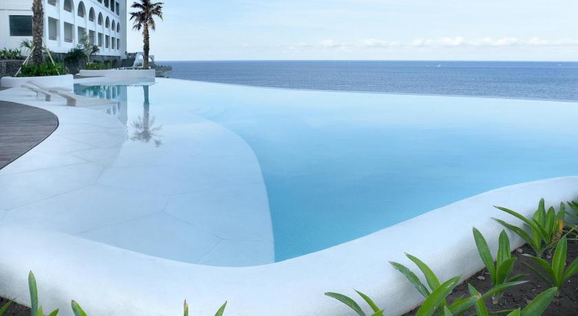 a beach with a pool and a large swimming pool, Royal Avila Boutique Resort in Lombok