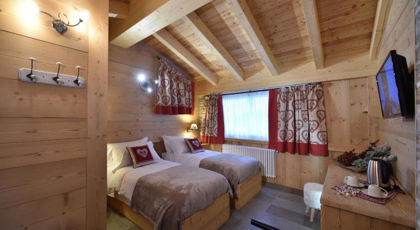 a bedroom with a bed and a window, Il Cuore Del Cervino in Valtournenche