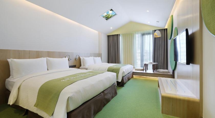 a hotel room with two beds and a large window, CHECKinn MAGI Kids in Yilan