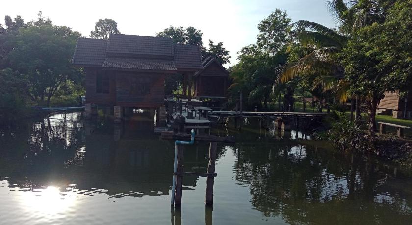 a large body of water with a dock, Home Style Resort in Buriram