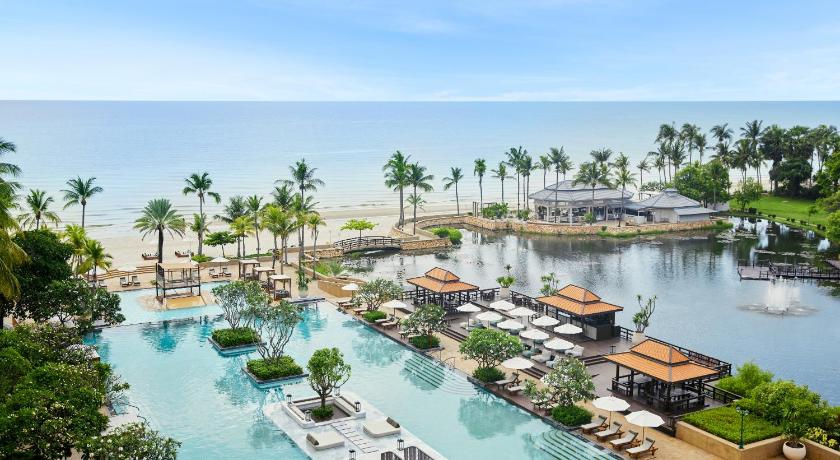 a large body of water with palm trees, Dusit Thani Hua Hin Hotel  (SHA Extra Plus) in Hua Hin / Cha-am