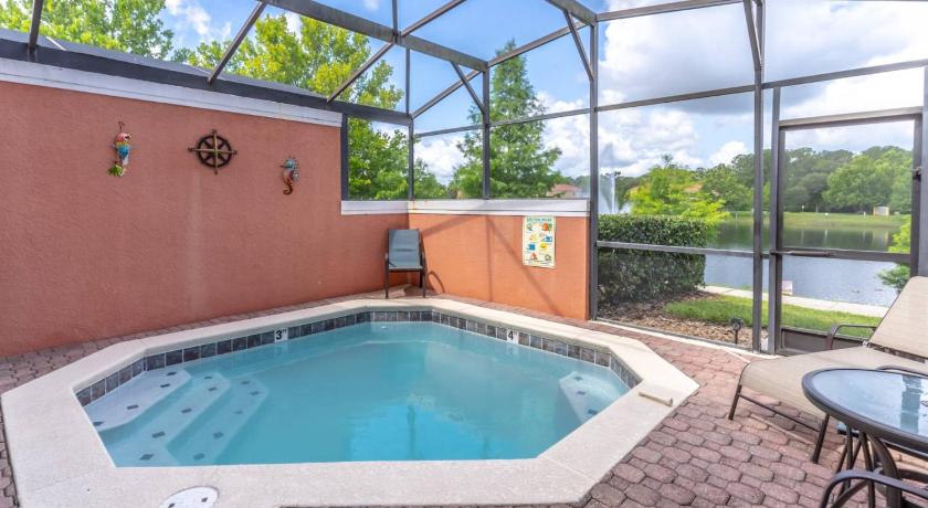 a swimming pool with a pool table and chairs, 3175 Encantada in Orlando (FL)