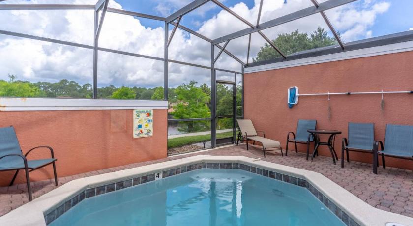 a pool with chairs and a pool table in it, 3175 Encantada in Orlando (FL)