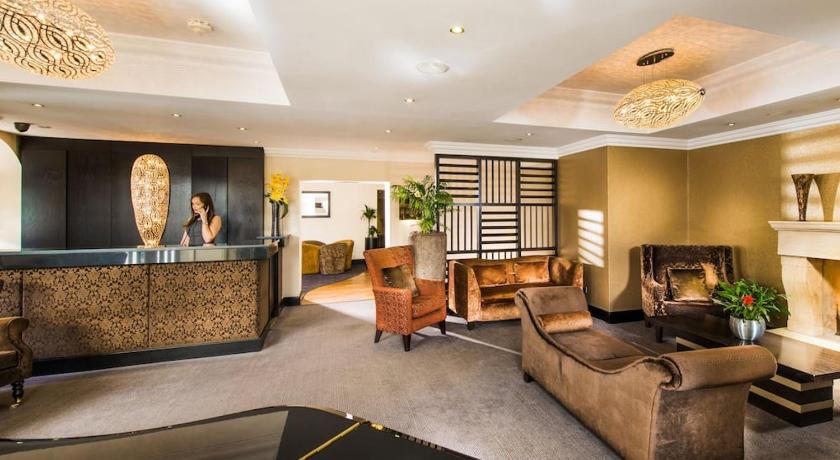 a living room filled with furniture and a large window, The Popinjay Hotel and Spa in Rosebank