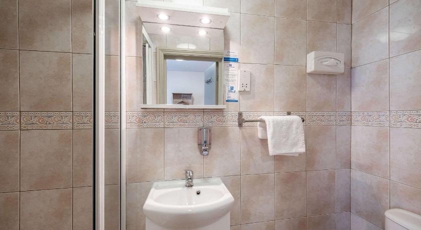 a bathroom with a sink, toilet and mirror, Comfort Inn Edgware Road W2 in London