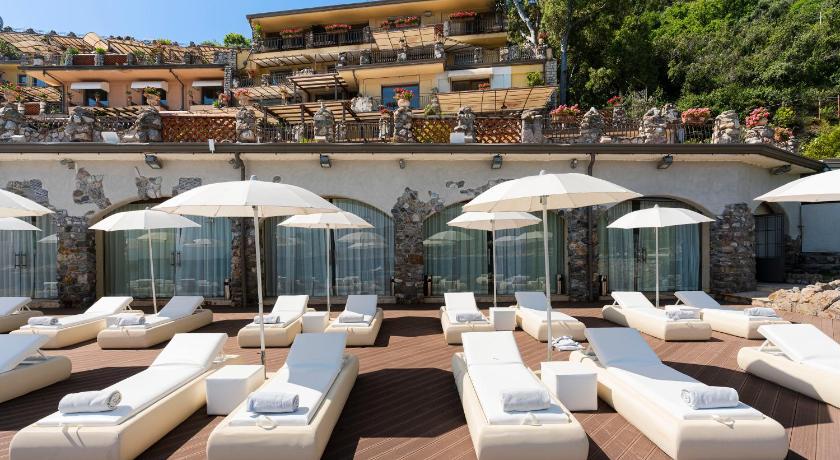 a patio area with chairs, tables and umbrellas, Atlantis Bay - VRetreats in Taormina