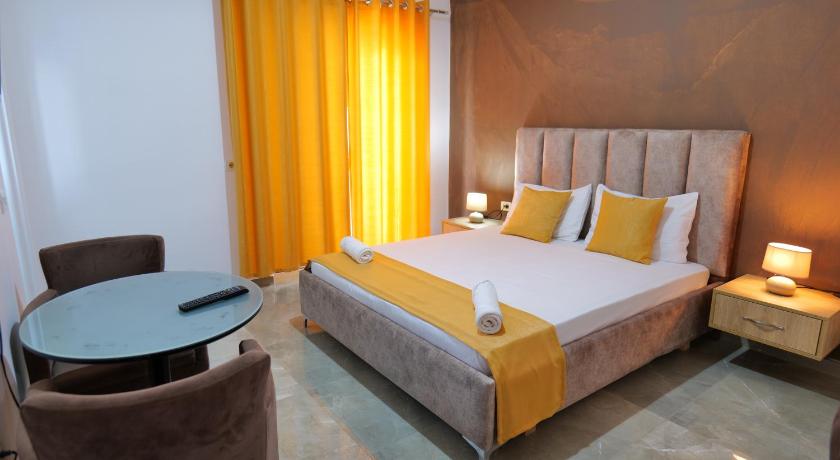 a hotel room with a large bed and two lamps, HOTEL ADI-VERA in Saranda
