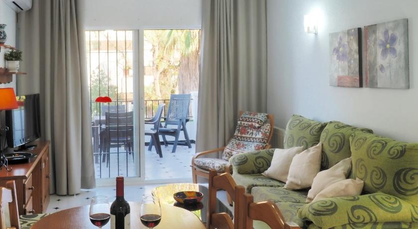 a living room filled with furniture and a tv, Nerjavacaciones - El Califa in Nerja