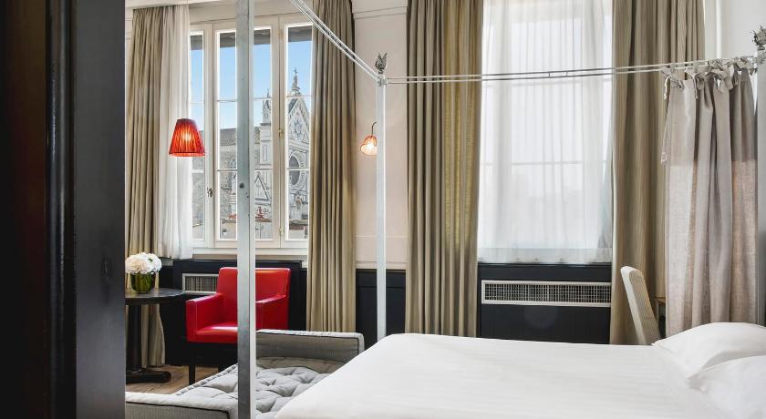 a hotel room with a bed and a window, Relais Santa Croce By Baglioni Hotels in Florence