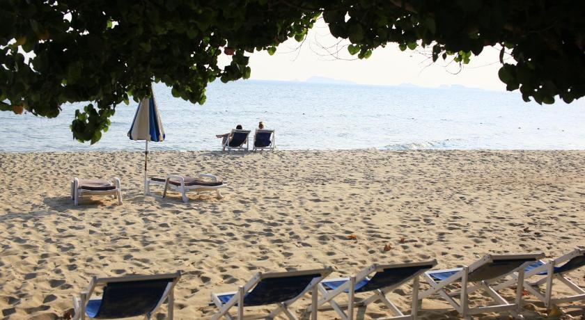 a beach with chairs and umbrellas on it, Novotel Rayong Rim Pae Resort in Rayong