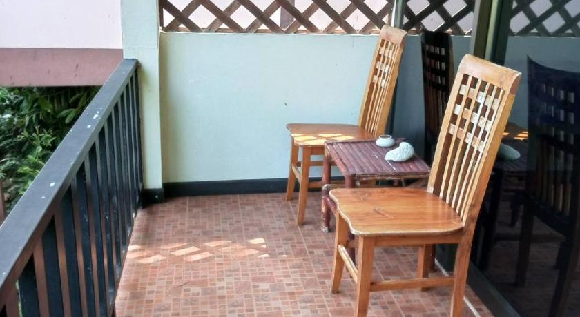 a wooden bench sitting in front of a patio, Faye Orchid Resort in Koh Chang