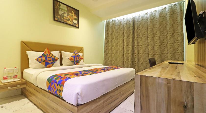 a bedroom with a bed, desk and a lamp, Hotel Good Vibe Near Delhi Airport in New Delhi and NCR