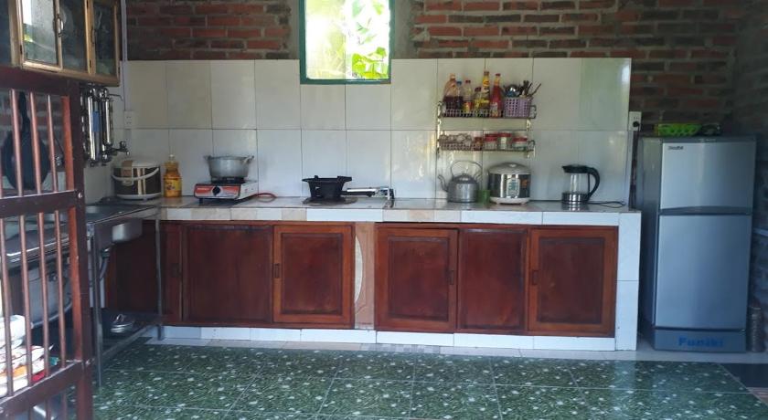 a kitchen with a stove, sink, and cabinets, Mina House in Hạ Long